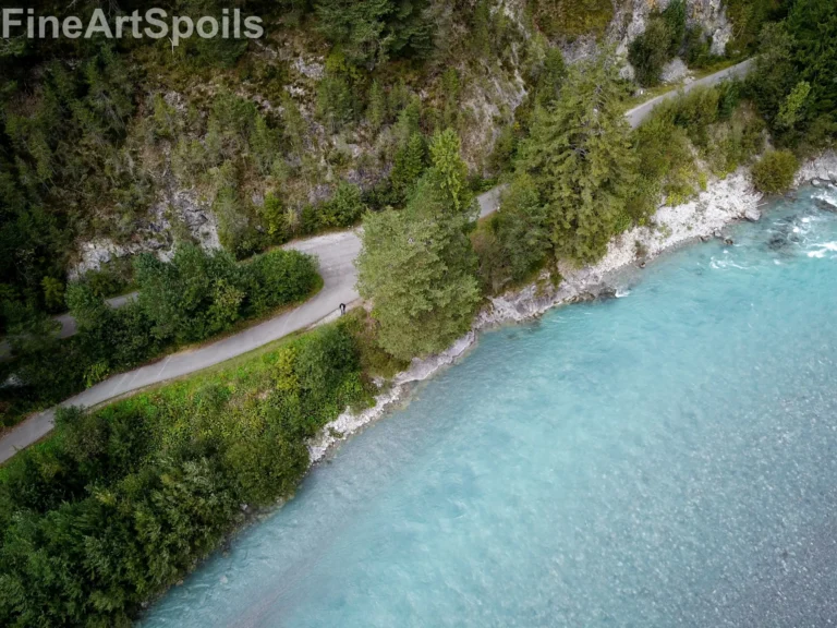Aerial View of Turquoise Glacial River and Forest Road